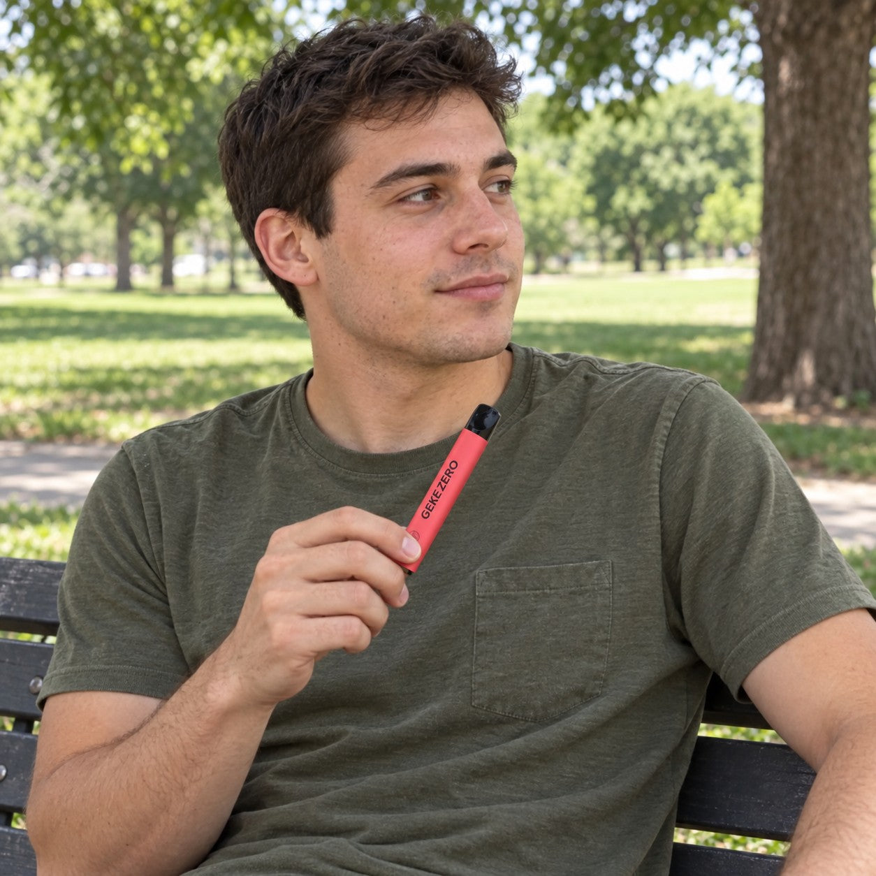 Illustrative scene: Young adult man holding the red Watermelon stick on a park bench
